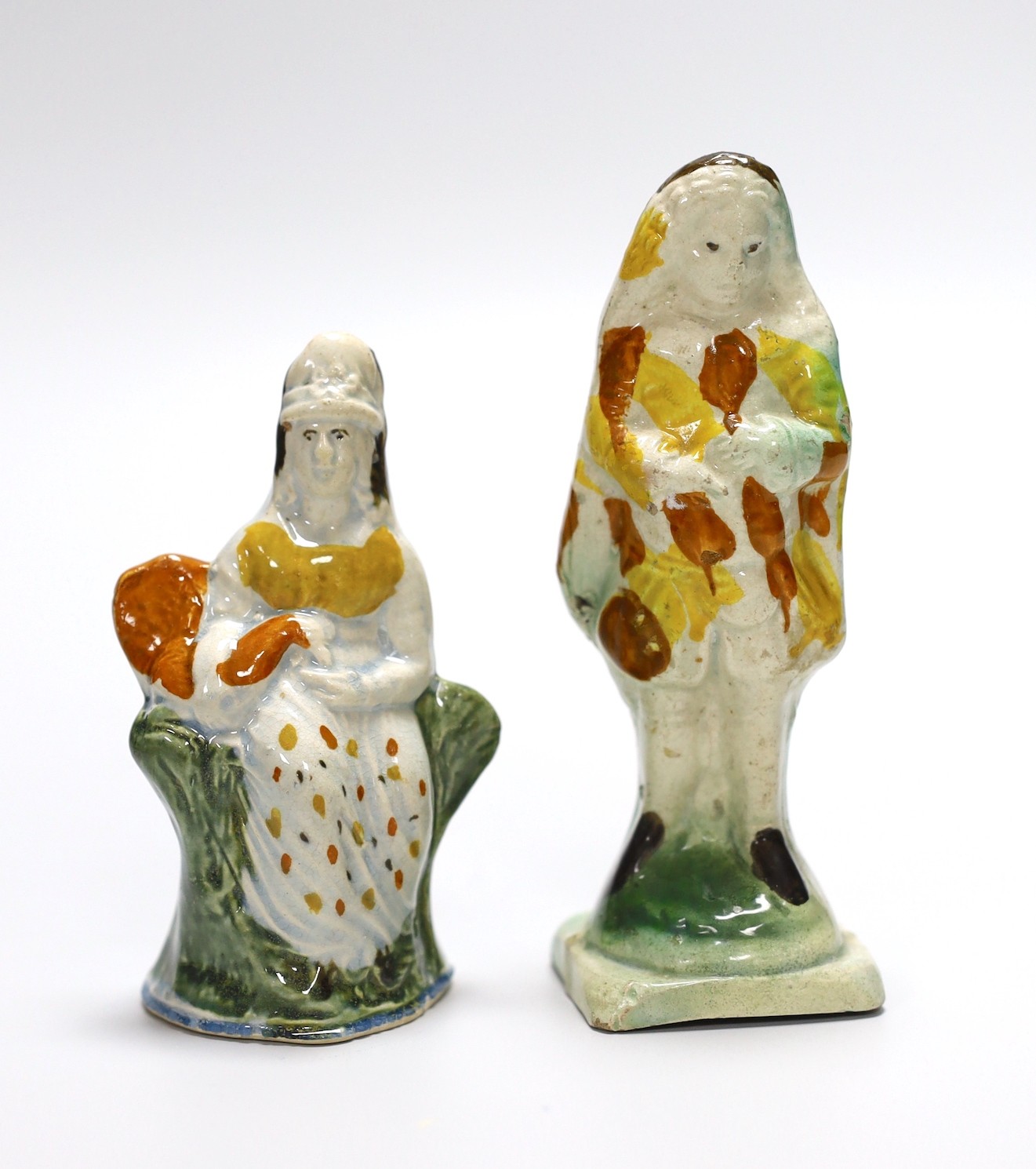 Two Georgian slip-cast Prattware figures and a Victorian salt glazed stoneware novelty pistol liquor flask, 24cm (3)